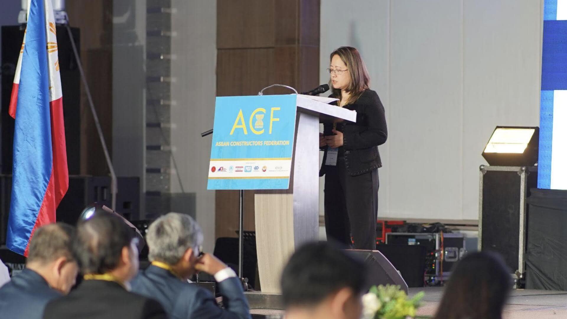 Woman giving a presentation on stage