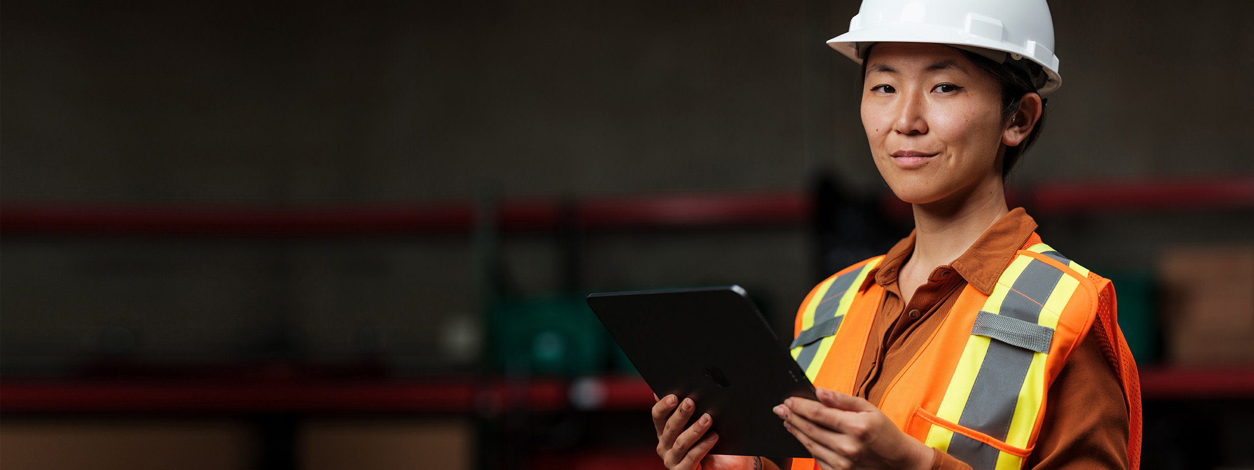 Woman holding a tablet and looking at the camera