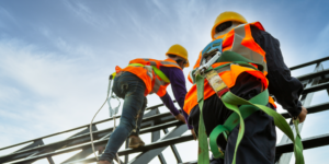 Photo of construction workers on scaffolding all wearing the proper personal protective equipment